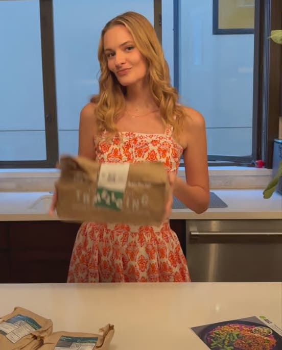 Anna unboxing a HelloFresh delivery in her kitchen
