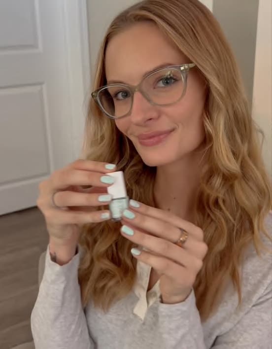 Anna holding a bottle of nail polish from a 213Deli drop